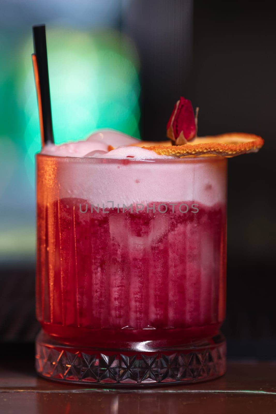 A beautiful bright cocktail. Restaurant, a glass with a drink is on the table.