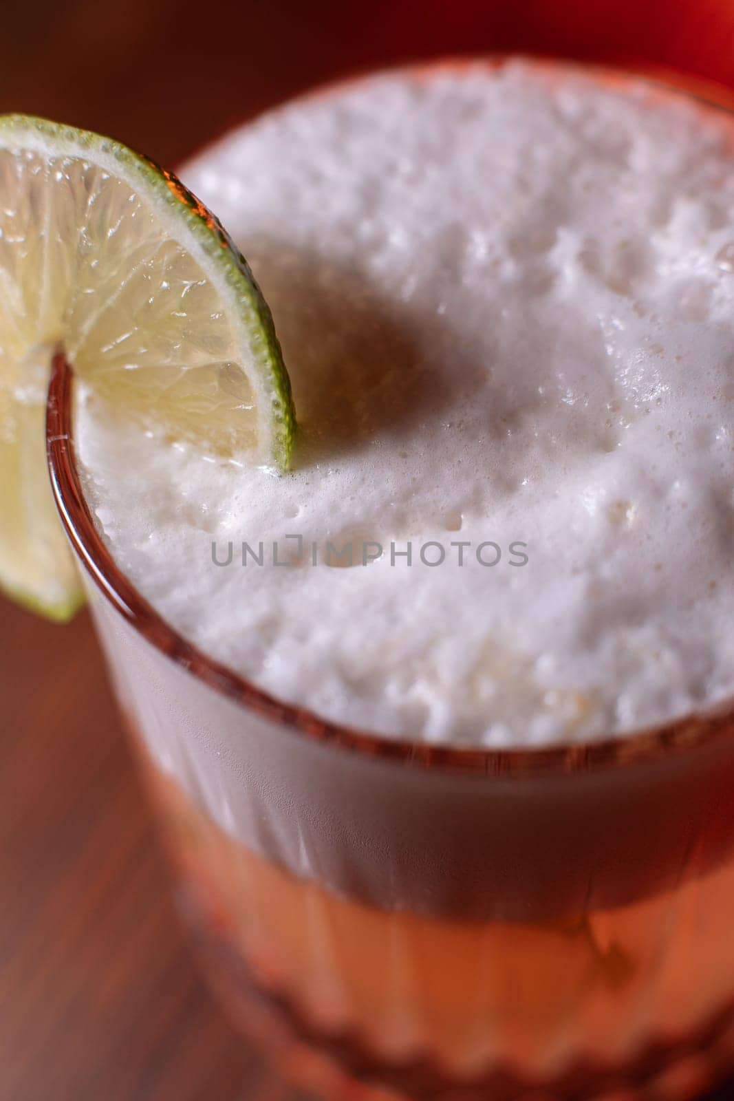 A beautiful bright cocktail. Restaurant, a glass with a drink is on the table.