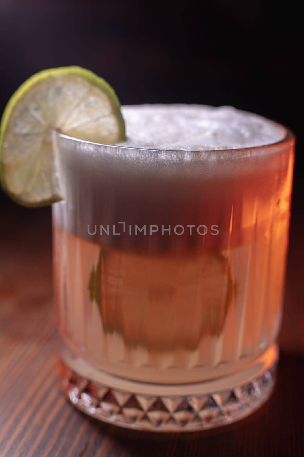 A beautiful bright cocktail. Restaurant, a glass with a drink is on the table.