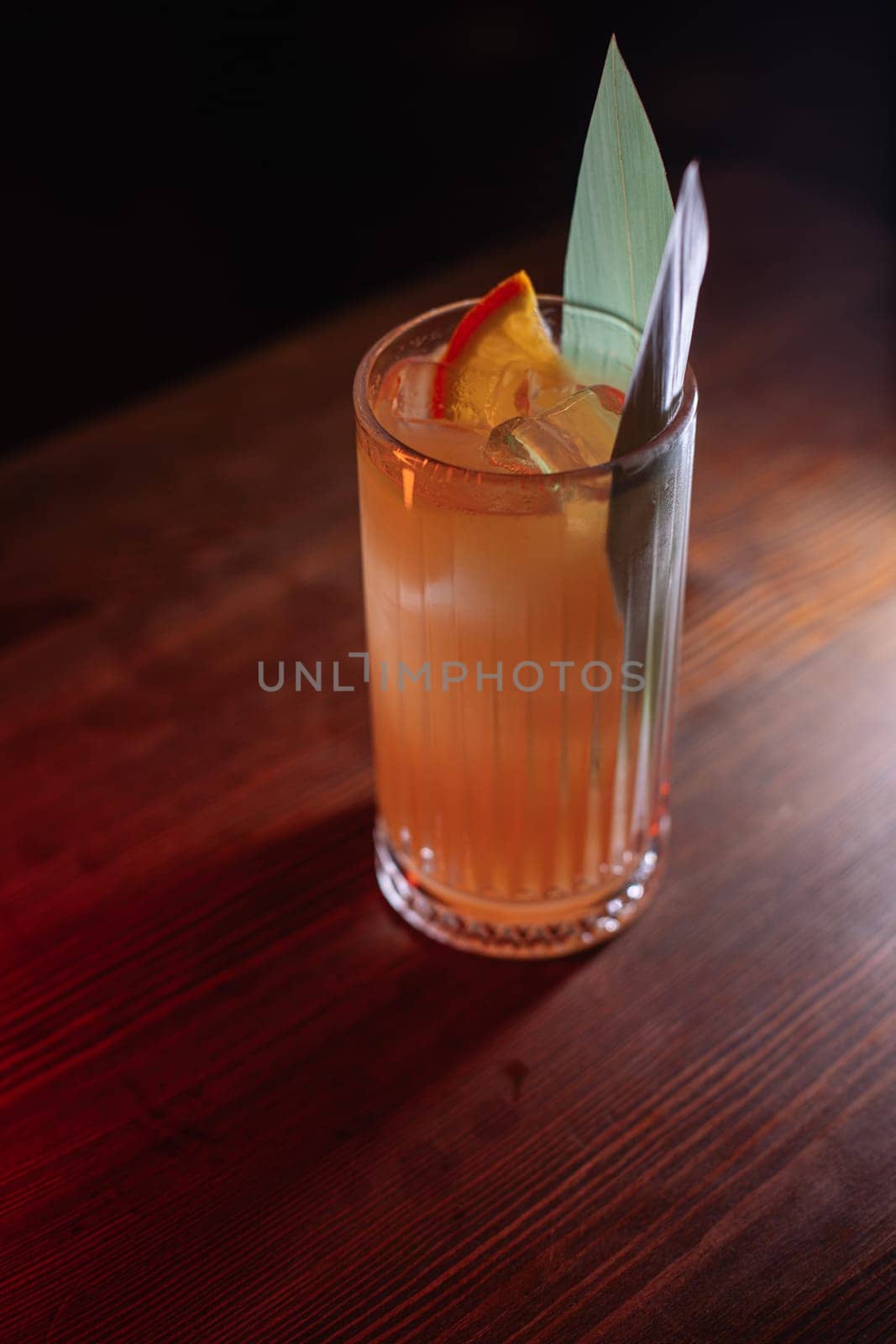 A beautiful bright cocktail. Restaurant, a glass with a drink is on the table.