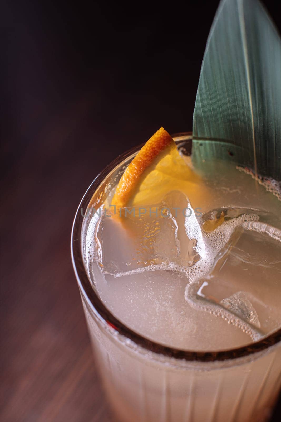 A beautiful bright cocktail. Restaurant, a glass with a drink is on the table.