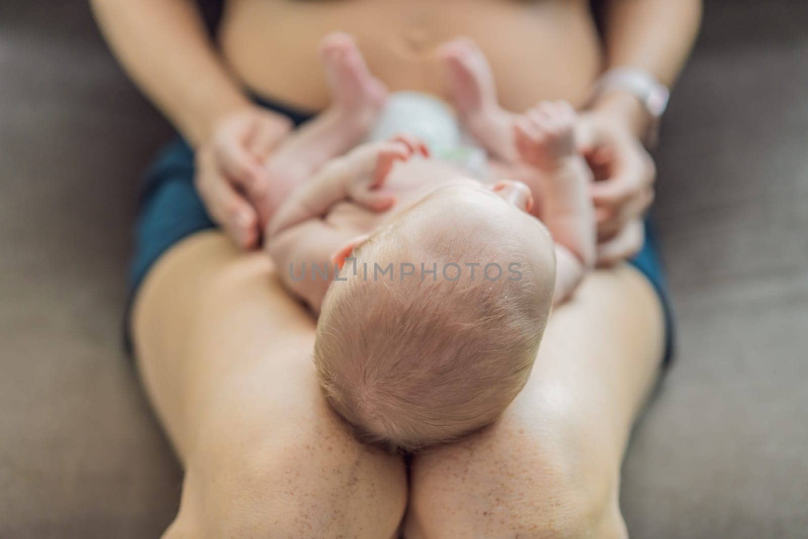 A newborn baby rests peacefully on the mother lap, feeling warmth, security, and love. A tender moment of bonding, trust, and comfort, symbolizing early childhood and the deep connection between mother and child.