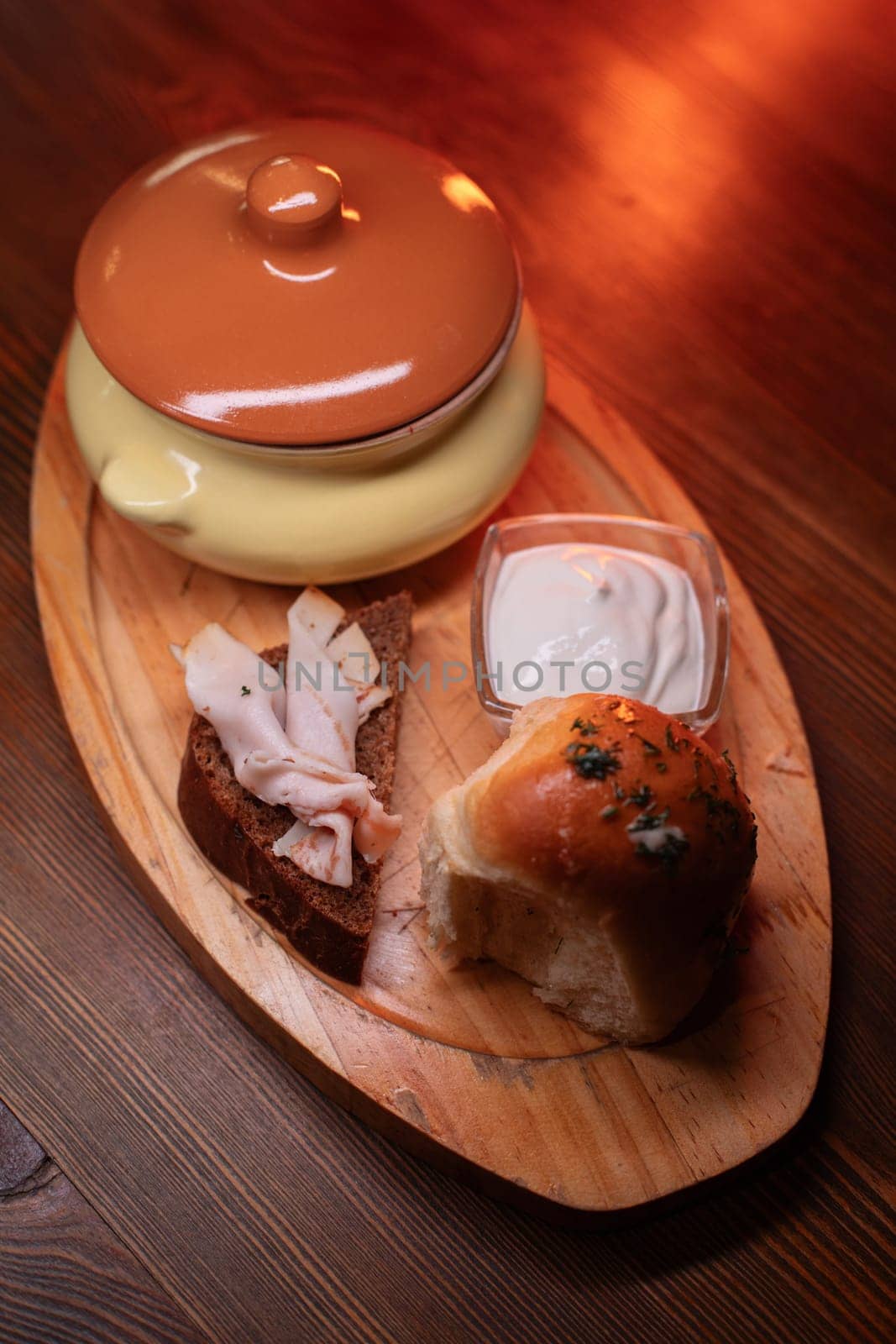 Restaurant dish borscht, delicious bread with bacon, sour cream, bun. A delicious photo for a menu, culinary website, or an advertisement for catering establishments