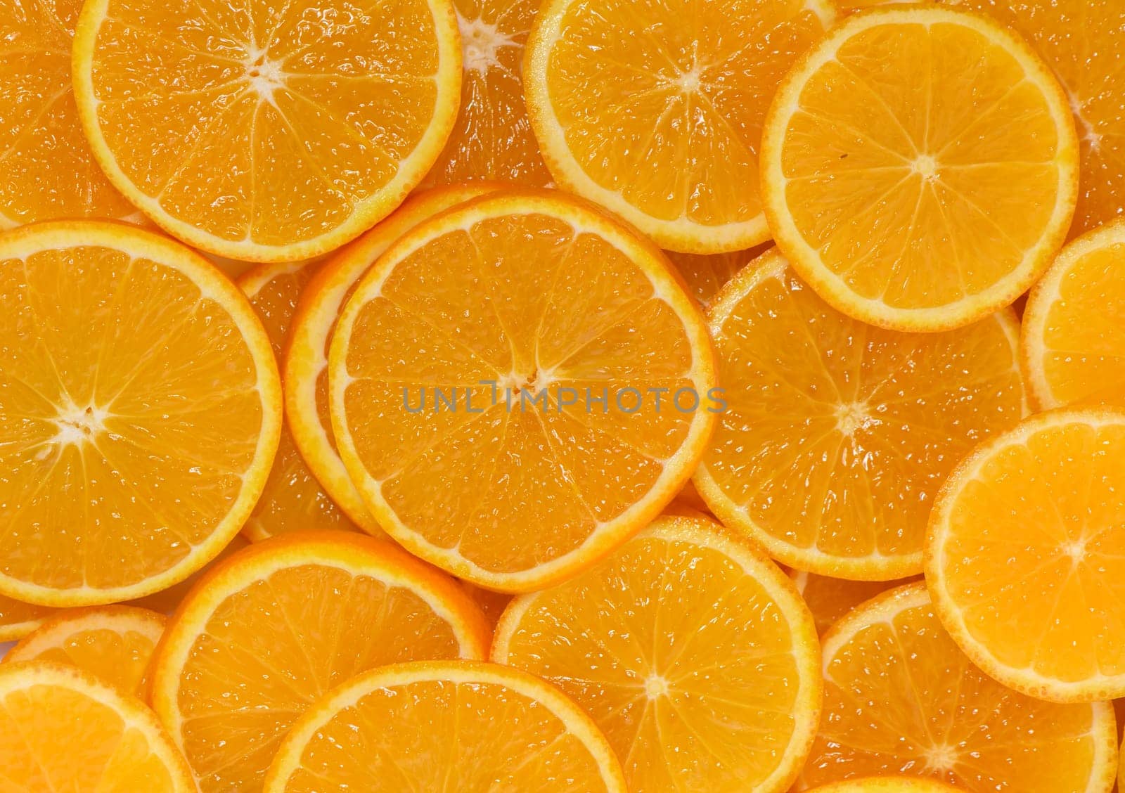 Vibrant orange slices layered together showcase their juicy texture and rich color, inviting fresh flavor and health.