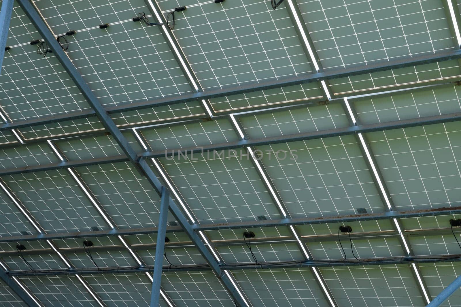 Energy-efficient solar panels capture sunlight, showcasing green technology on a contemporary structure's roof.