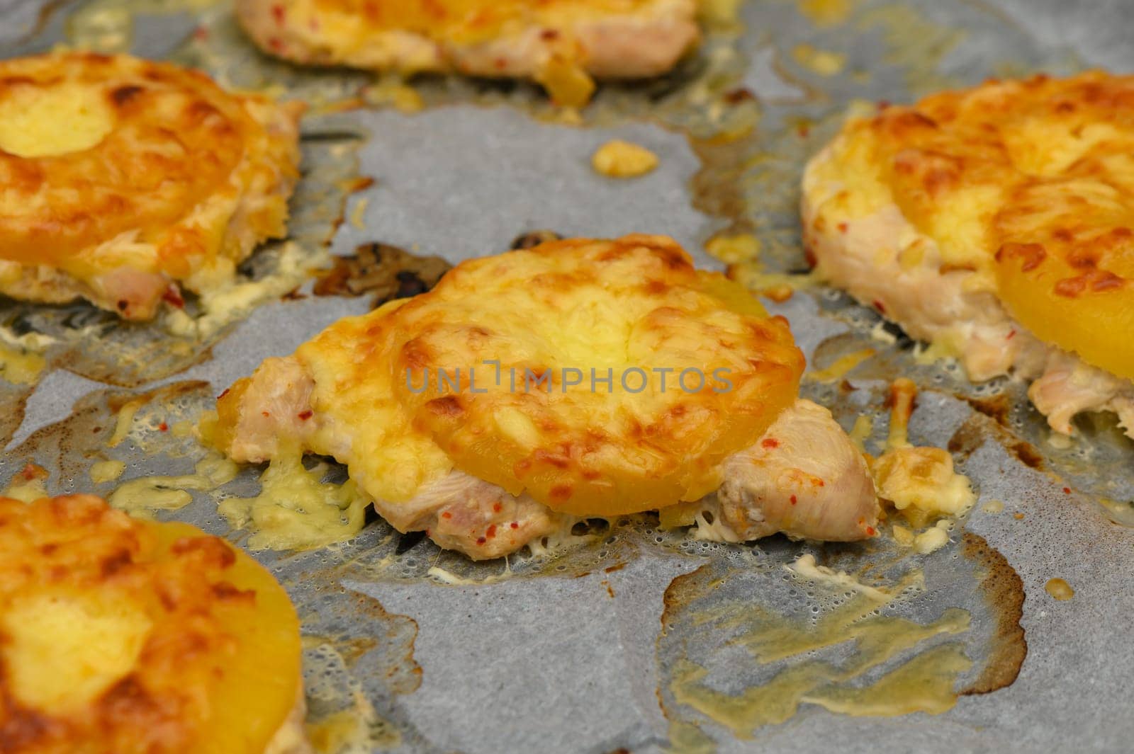 Juicy chicken fillets topped with pineapple rings and melted cheese, creating a delightful savory dish for dinner.