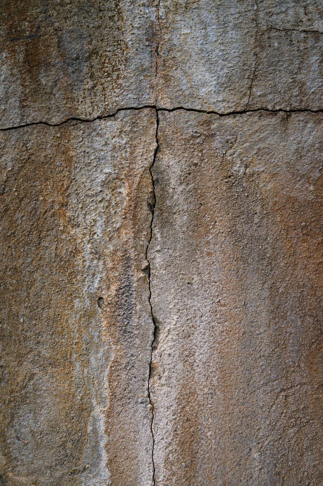 Surface displays jagged cracks and worn textures, telling a story of time and natural elements affecting its appearance.