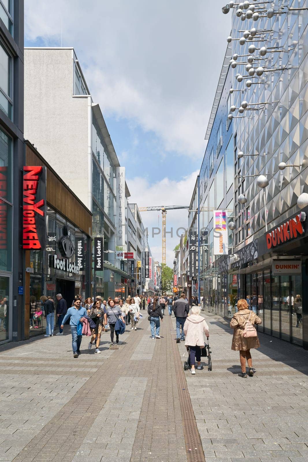 Cologne, Germany – May 19, 2024: People in Hohe Strasse, a popular shopping street in Cologne, Germany