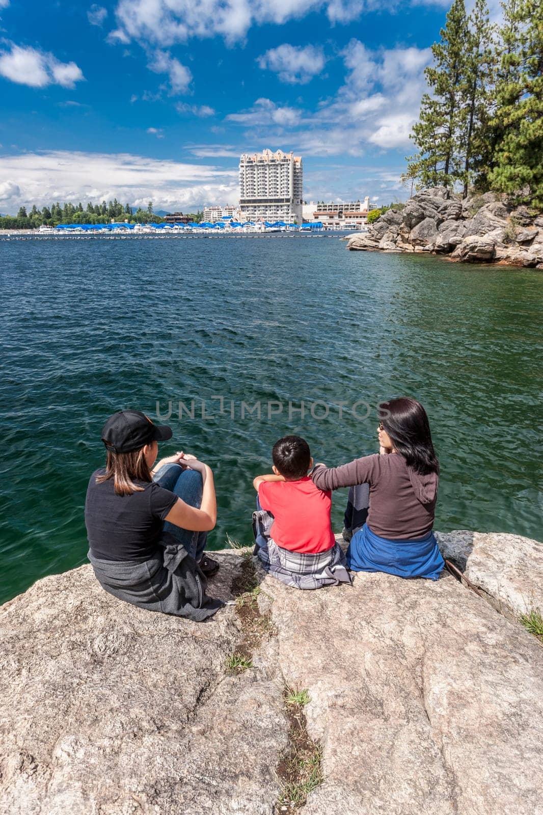 A mother and her two kids enjoying the view of Coeur d'Alene lake and the resort from Tubbs Hill.