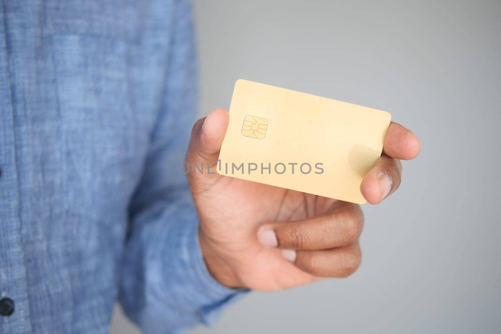 A person displays a blank card with a light gray background.