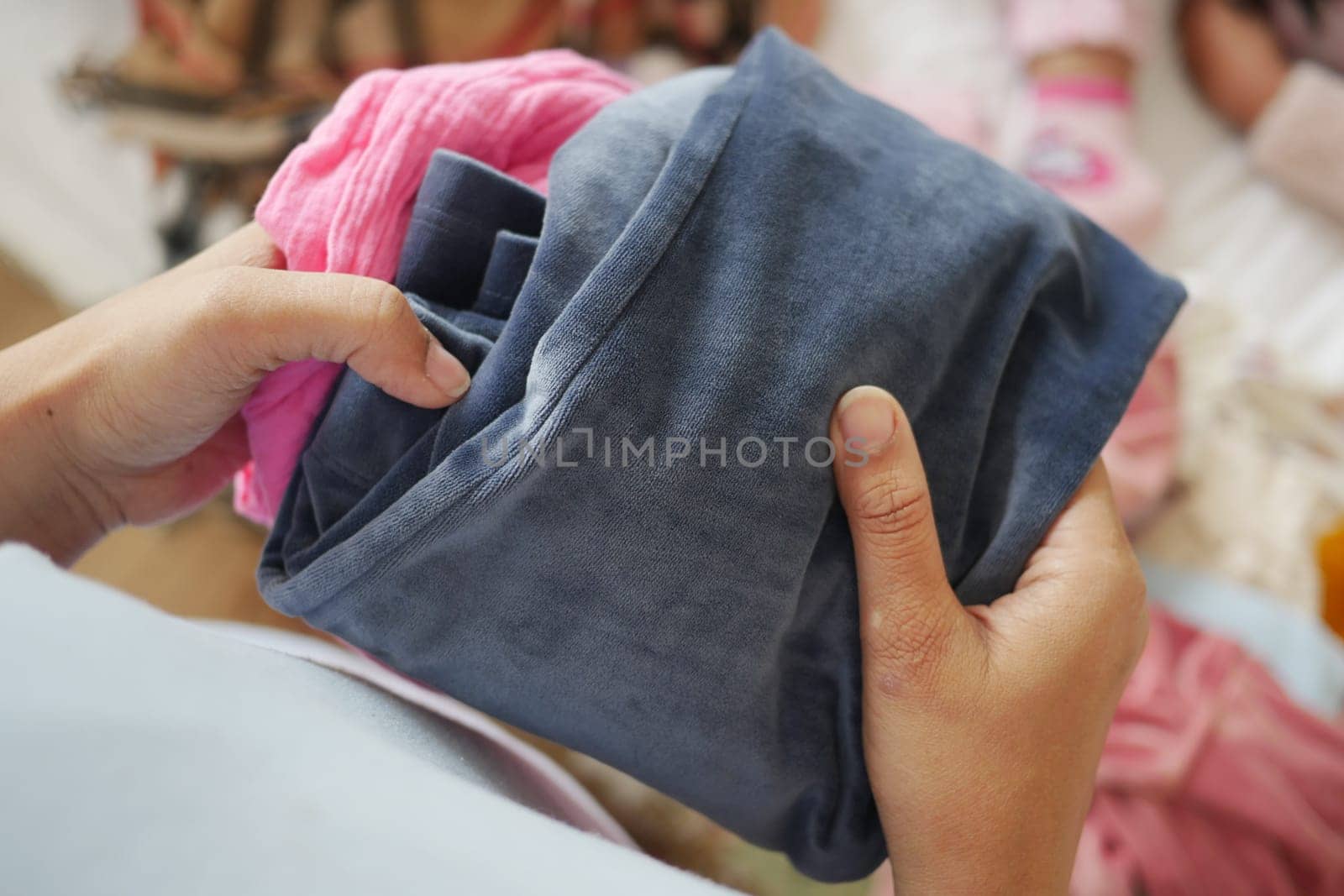 Person is folding laundry in a warm and inviting living space.