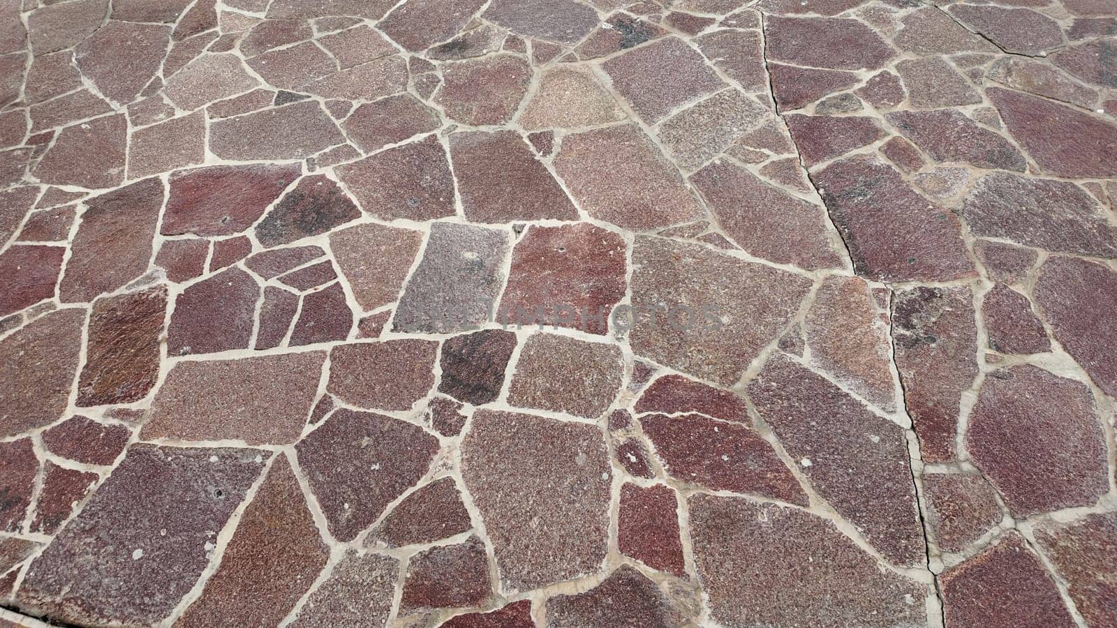 A detailed view of a stone pathway featuring rich textures and colors.