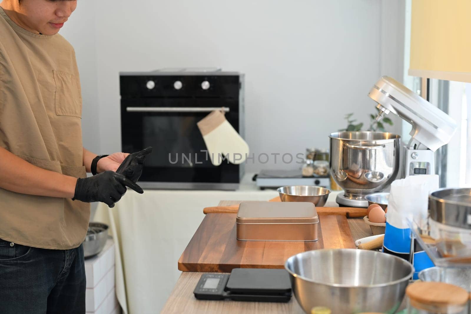 Small business entrepreneur preparing for cookie baking in a modern kitchen.