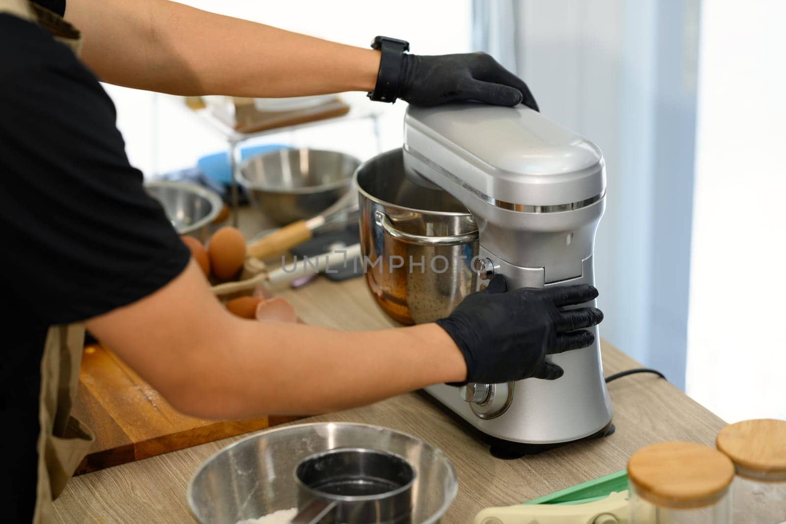 Cropped shot of young man mixing cookie dough with stand mixer.