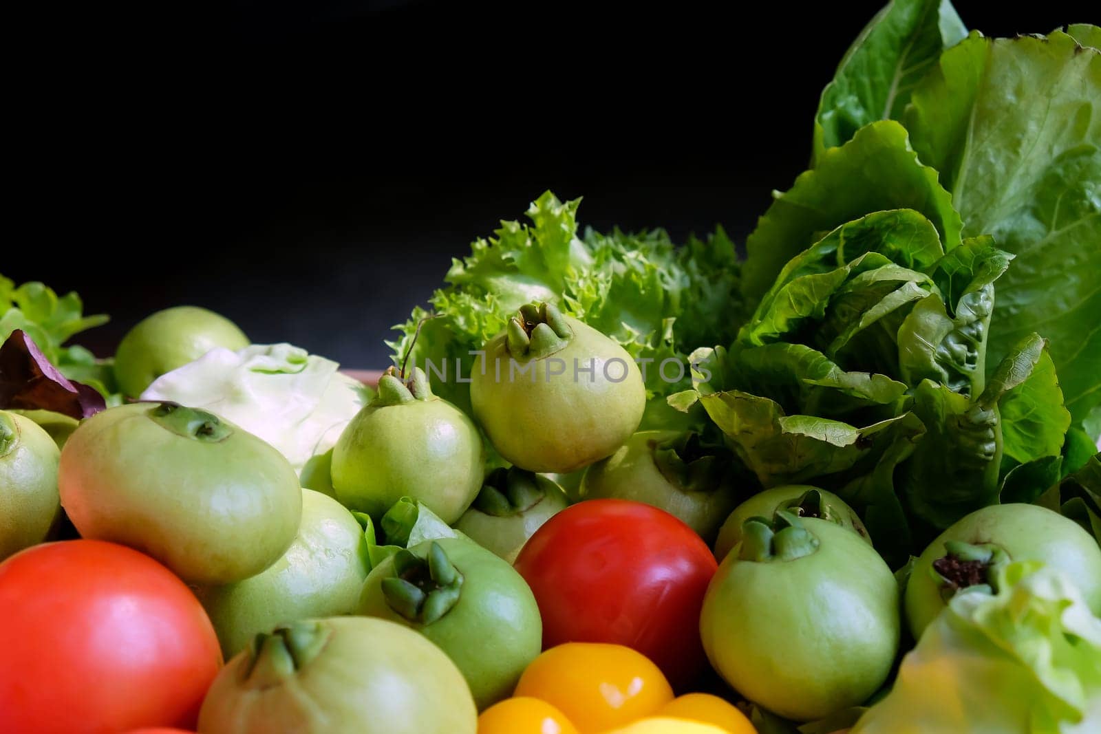 Vegetables in a basket on a dark background. Healthy food.