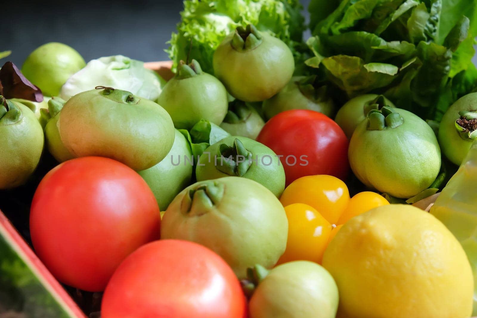 Variety of fresh vegetables in a wooden box. Selective focus.