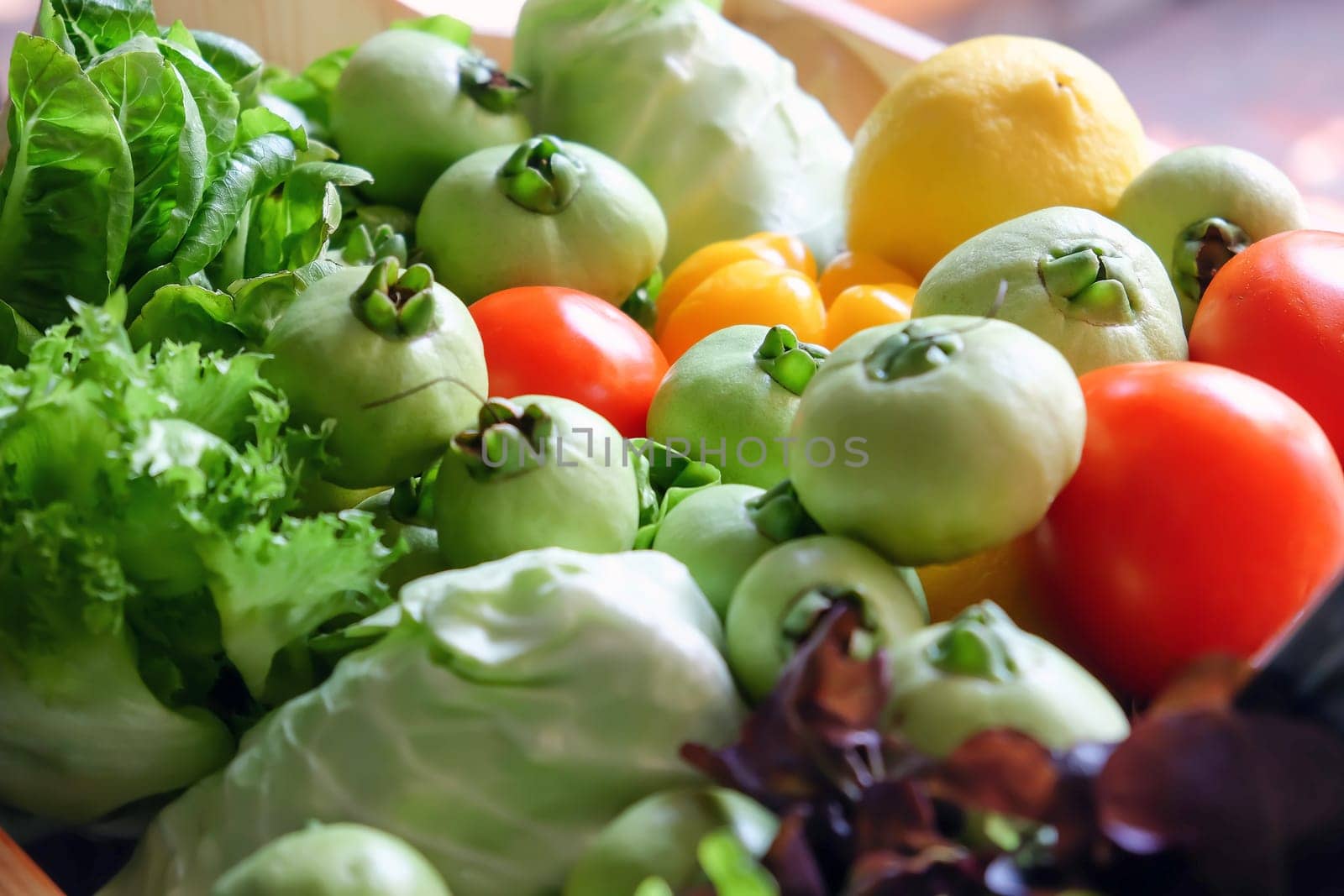 Variety of fresh vegetables in a wooden box. Selective focus.