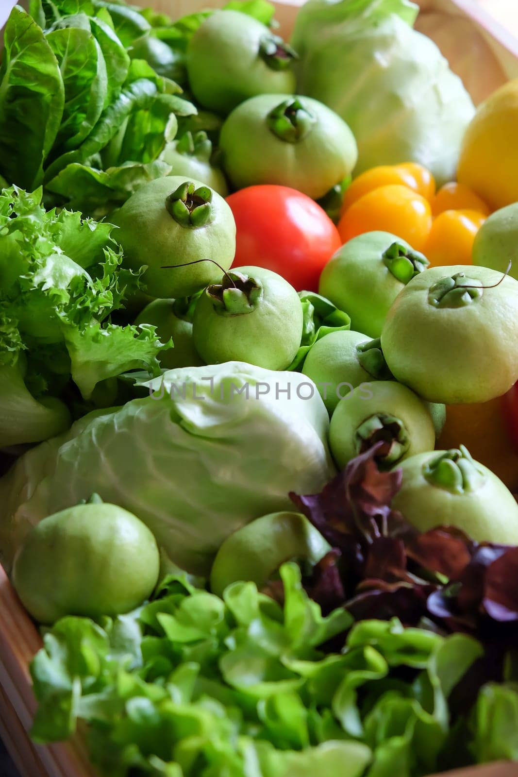 Variety of fresh vegetables in a wooden box. Selective focus.
