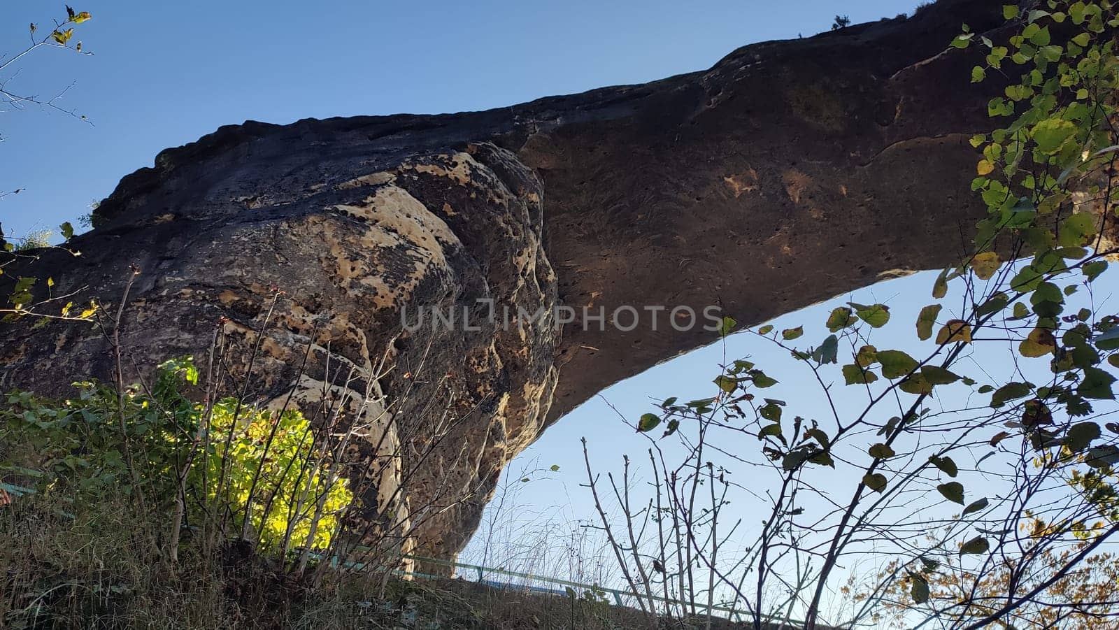 Natural rock arch green nature park blue sky landscape background trees summer day travel tourism Europe Czech Republic . High quality photo