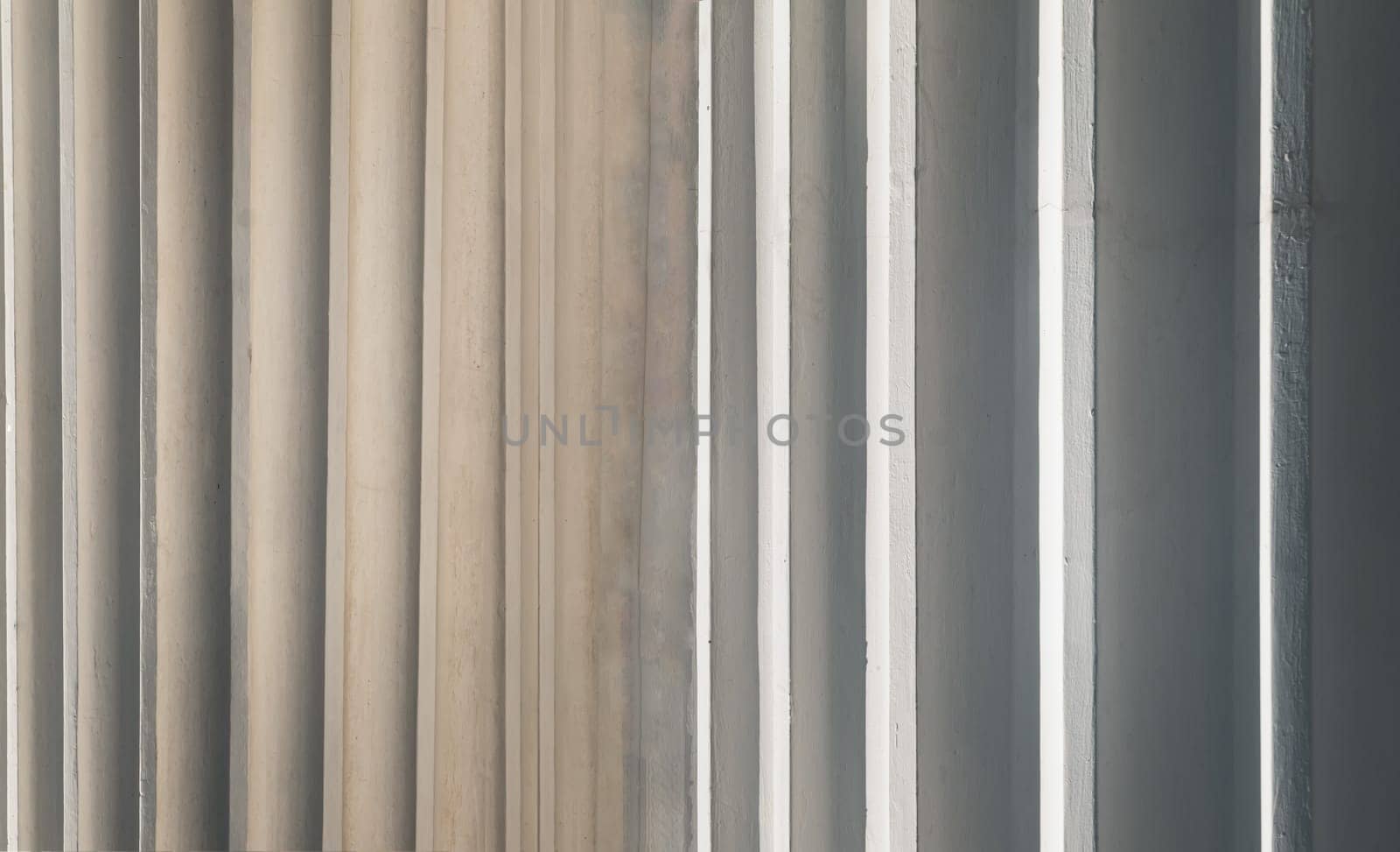 Sunlight shines passing through light channel of exterior of the concrete white walls background. use it as your Space for text, Design, Wallpaper and Poster, Selective focus.