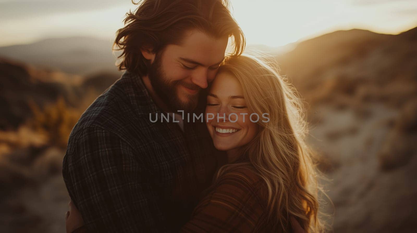 Portrait of happy young lovely couple smiling embracing outdoors against a sunset mountain landscape background