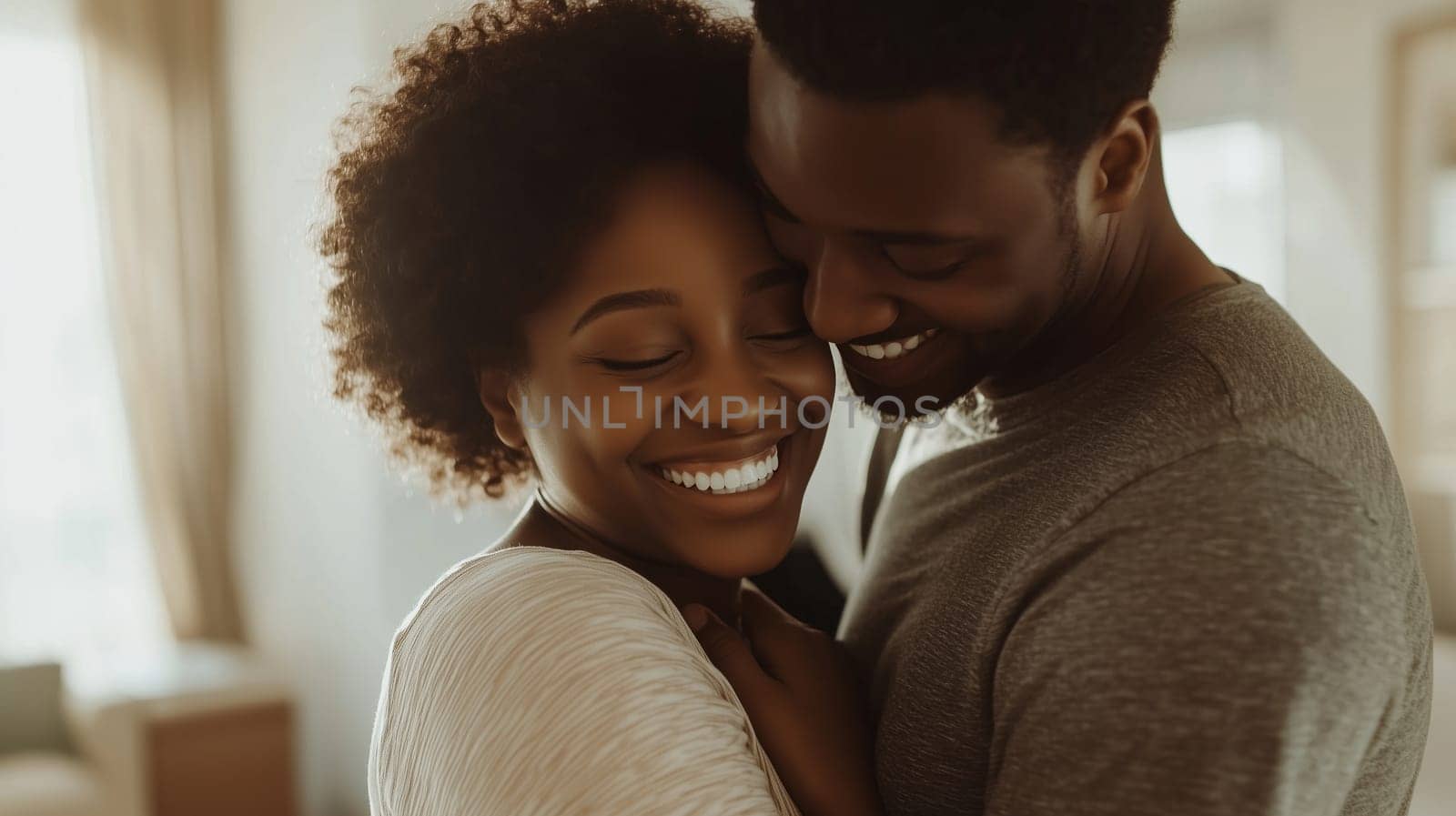 Portrait of happy young black American couple smiling embracing at home