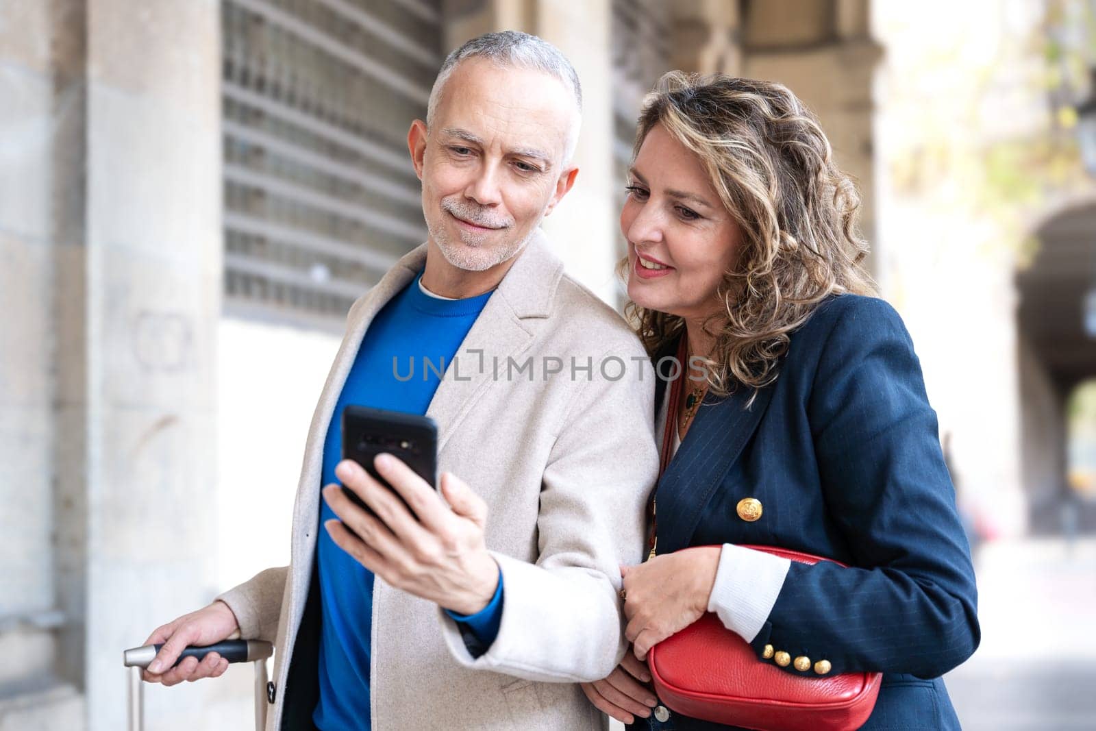 Traveler adult couple using smartphone or mobile phone to search information about hotels, shopping malls and transportation guides on the app. lifestyle and travel concept.
