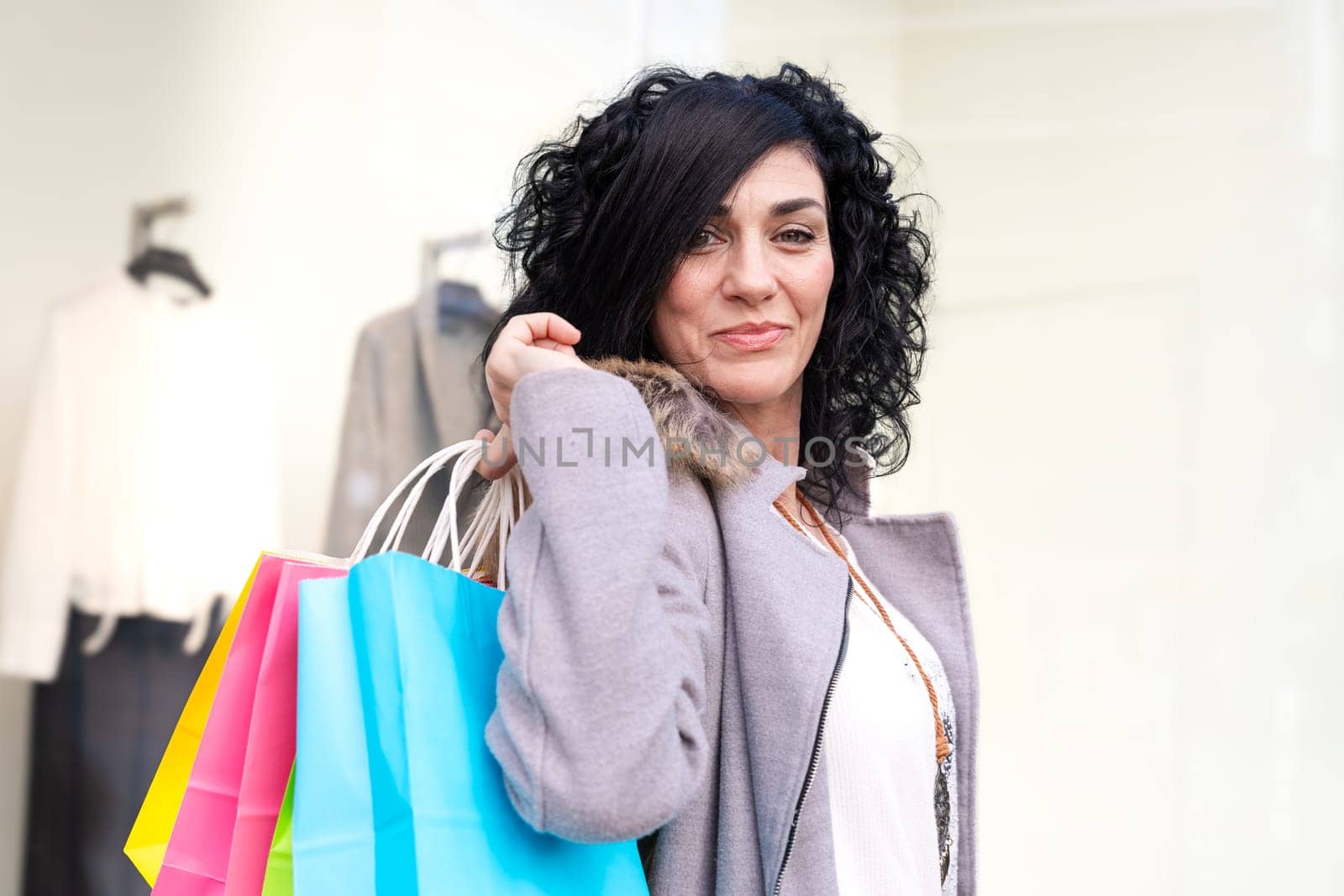 Woman shopping. Happy woman with shopping bags enjoying shopping. Consumerism, shopping, lifestyle concept