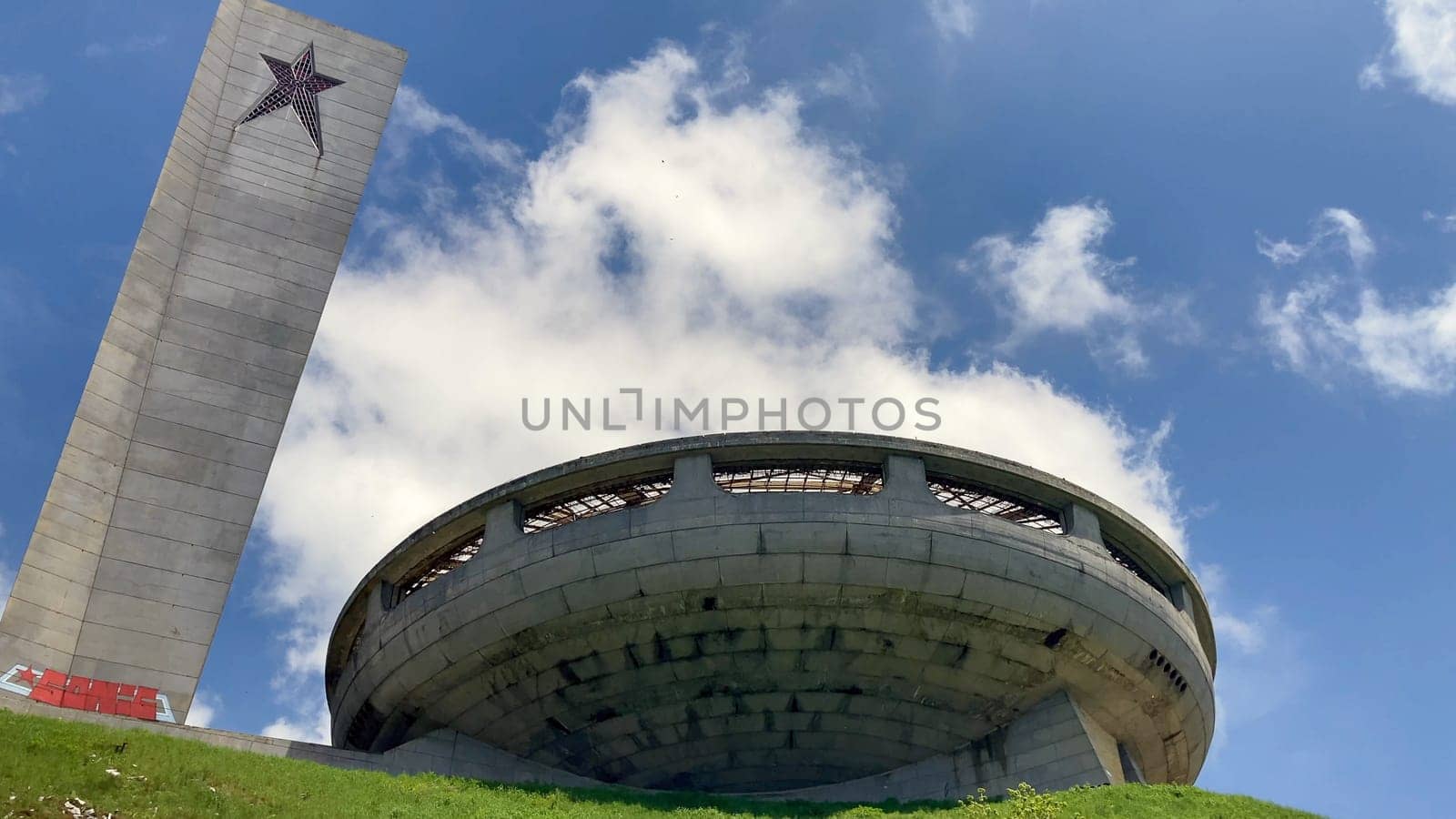 Monument Buzludzha, two torches on mountain top with spaceship background. Communist monument. Historical landmark from Bulgaria. Cloudy, sunny day - Europe