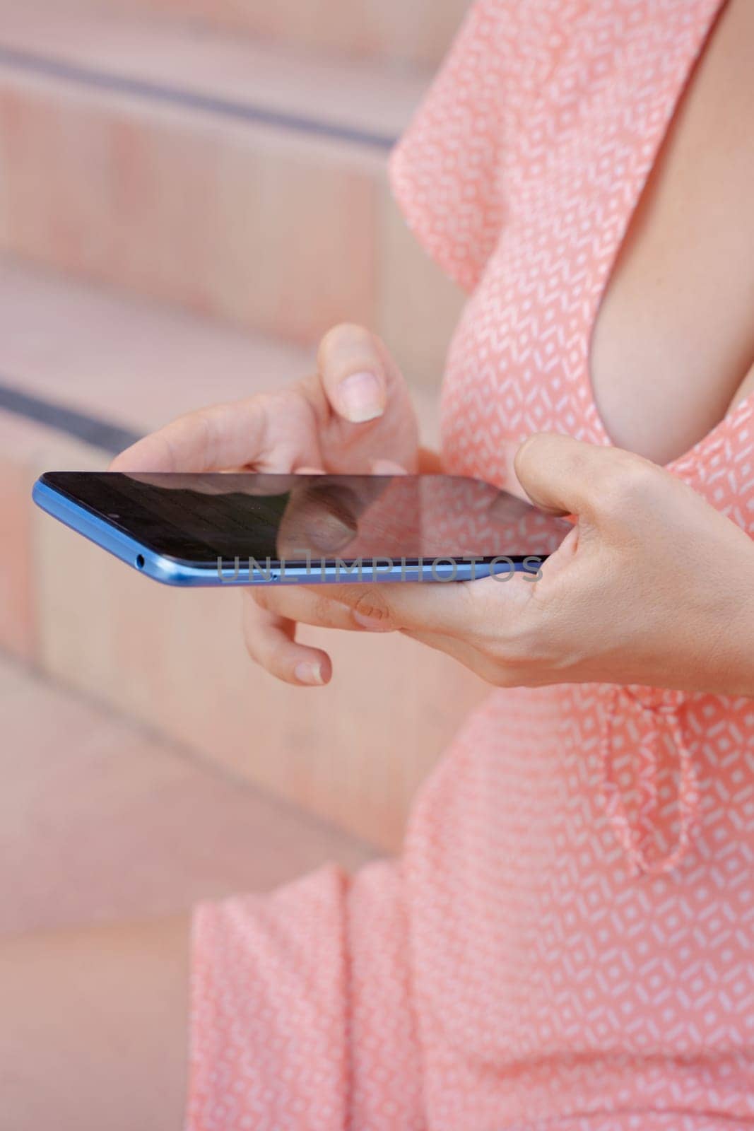 Woman hands typing on phone browsing social media