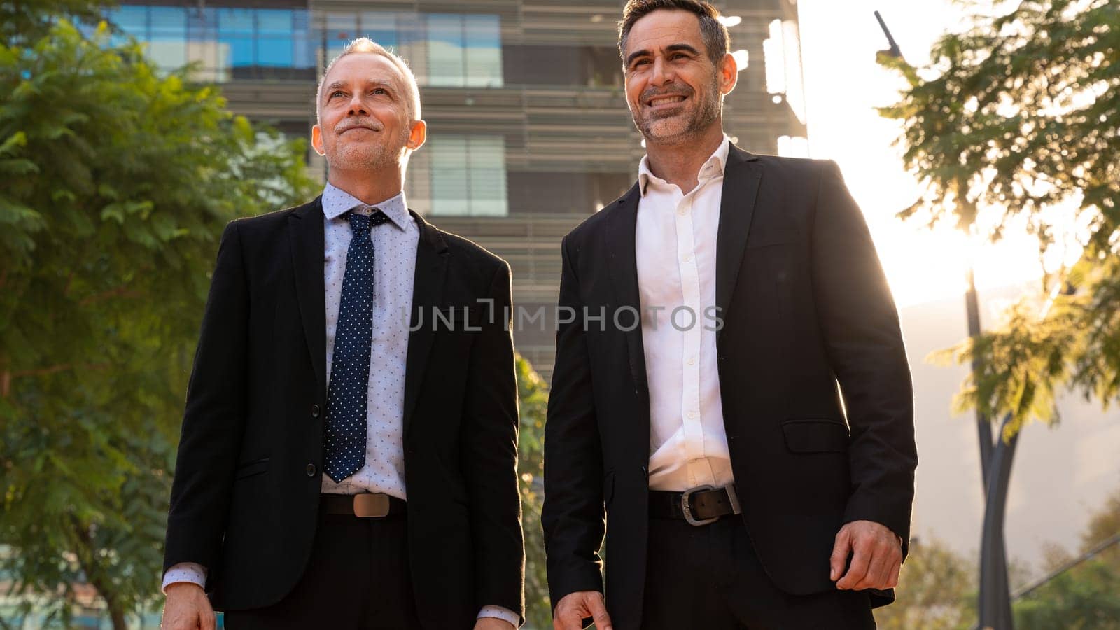 Portrait Of Two Trusted Business Colleagues Dressed In Formal Suit Walking Together Outside Work Center During Work Meeting.