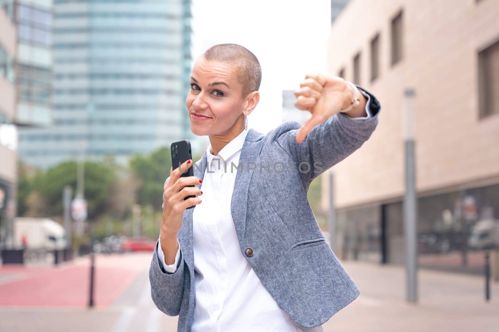 Middle adult woman, Caucasian woman, pointing with thumbs down. Angry facial expression.
