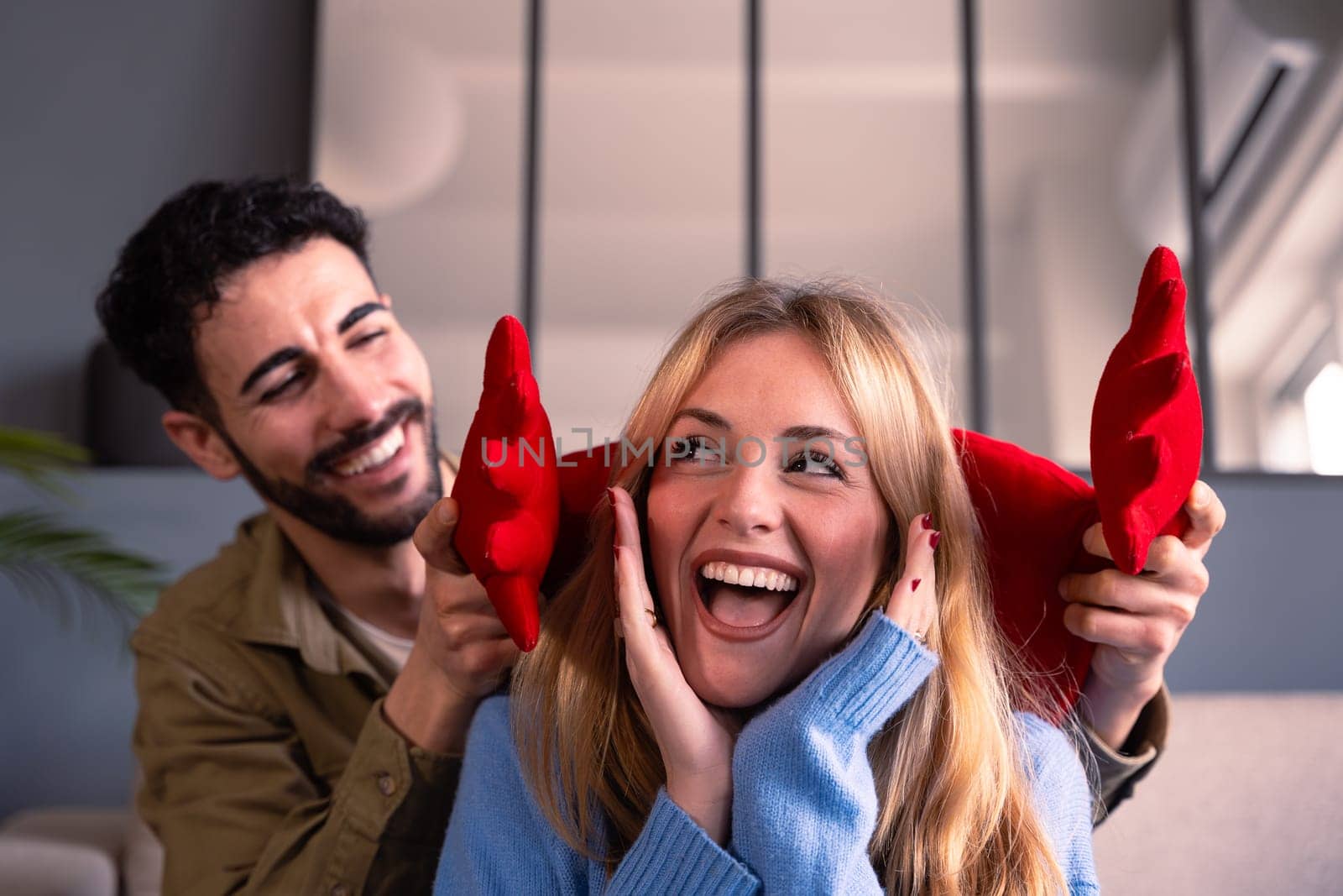 Young couple smiling with a giant heart. Valentine's Day.