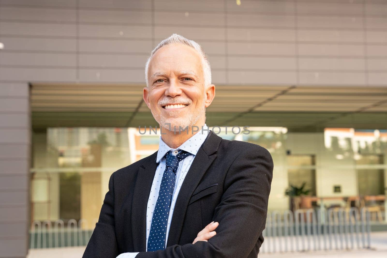 Professional, mature and smiling executive manager, proud lawyer, business leader in suit and tie looking at camera.