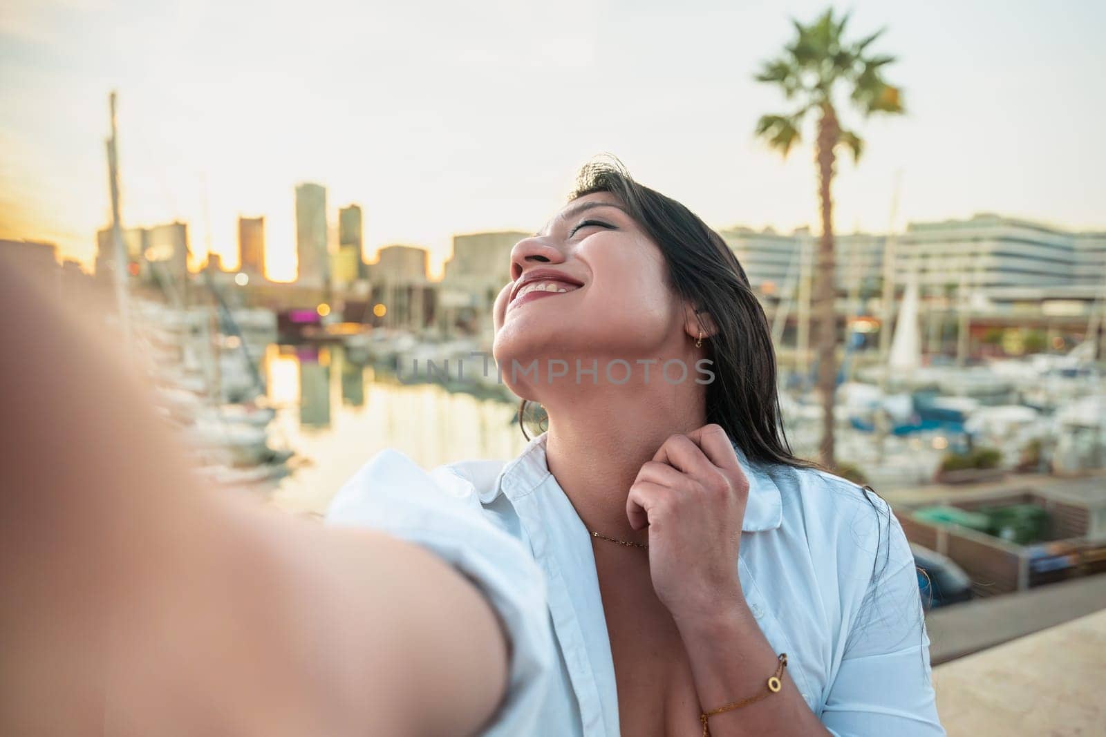 Happy female making a self-portrait with a smartphone.