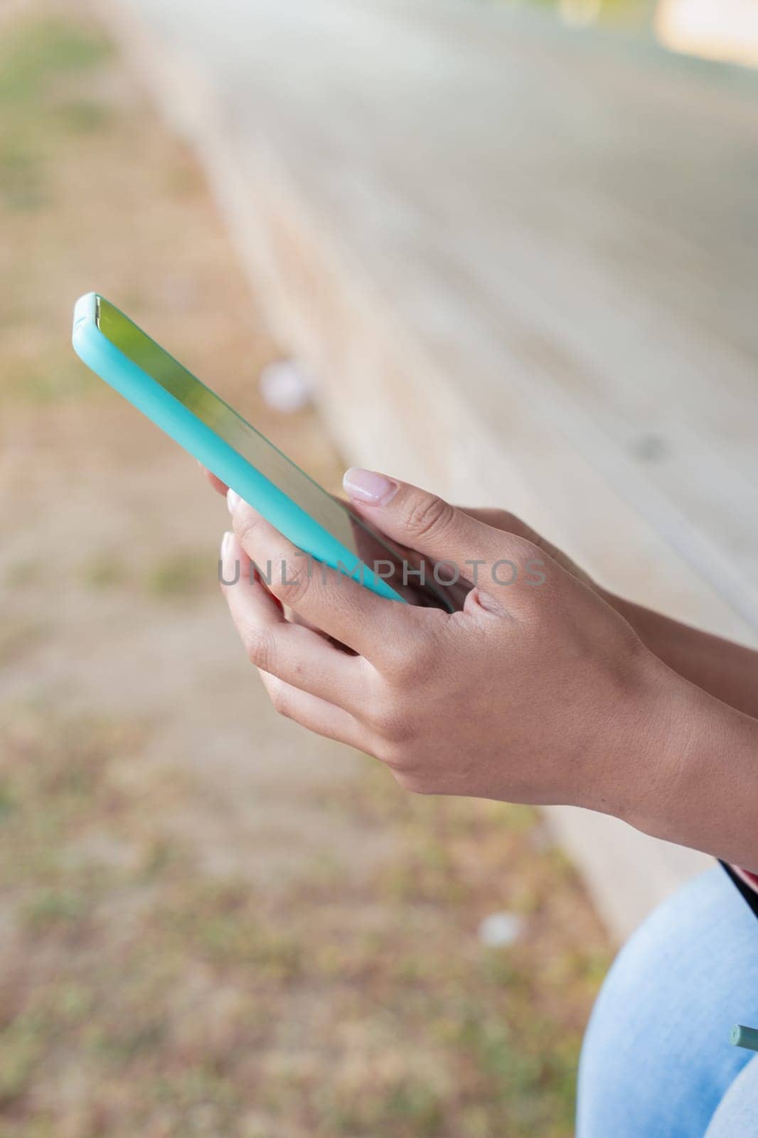 Woman hands typing on phone browsing mobile phone on social media
