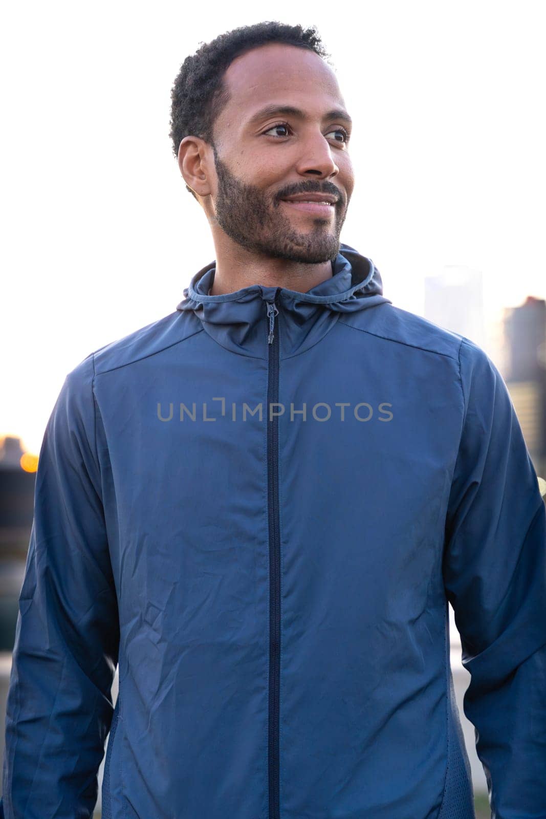 Happy man looking to the side. Man resting during his morning workout.