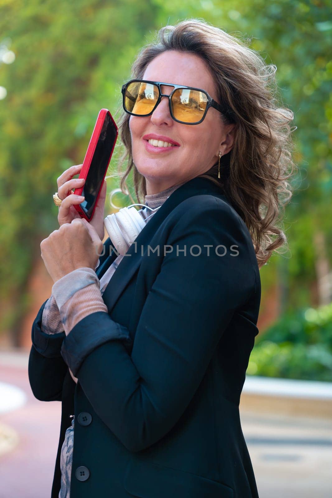 Beautiful average adult caucasian woman wearing glasses having a cell phone conversation.