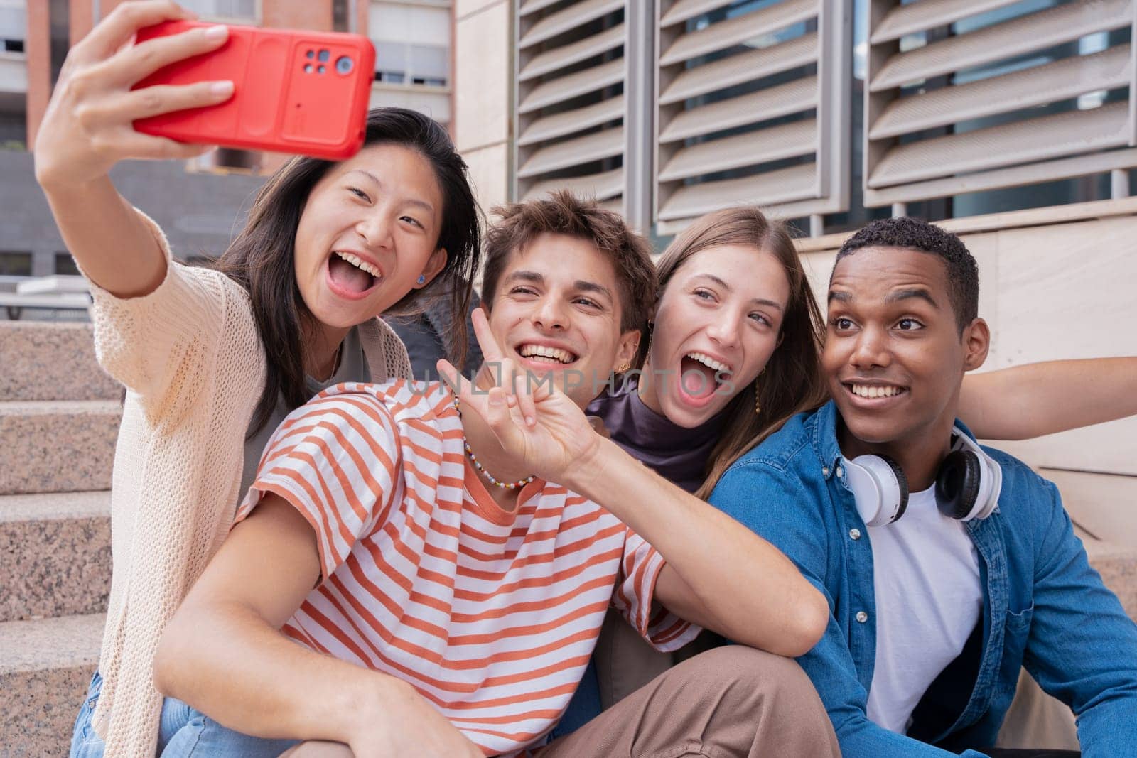 Happy multiethnic group of young friends take a selfie together on campus. multiracial students gathering in the city, concepts of youth, people lifestyle, diversity, teenage and urban life