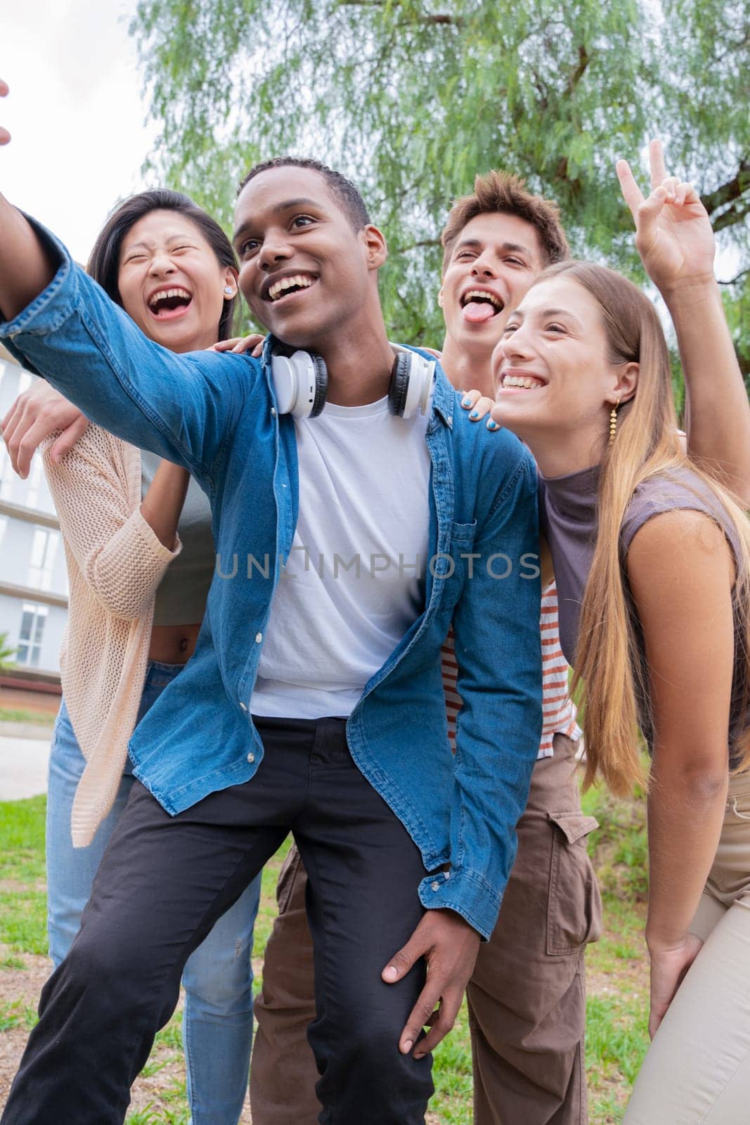 group of friends taking a selfie together and laughing together at the university.Technology or networking, connectivity and happy college people take a photo smiling for social media