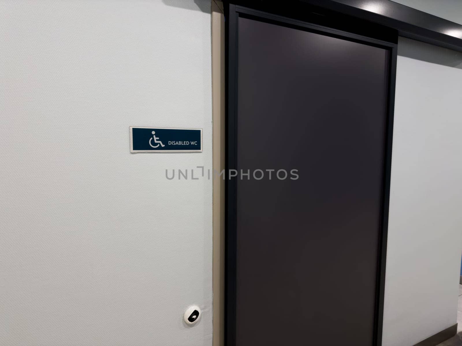 Entrance to toilet with sliding door for wheelchair users. Special toilet in public place for people with disabilities. Creating comfortable areas for people with mobility problems