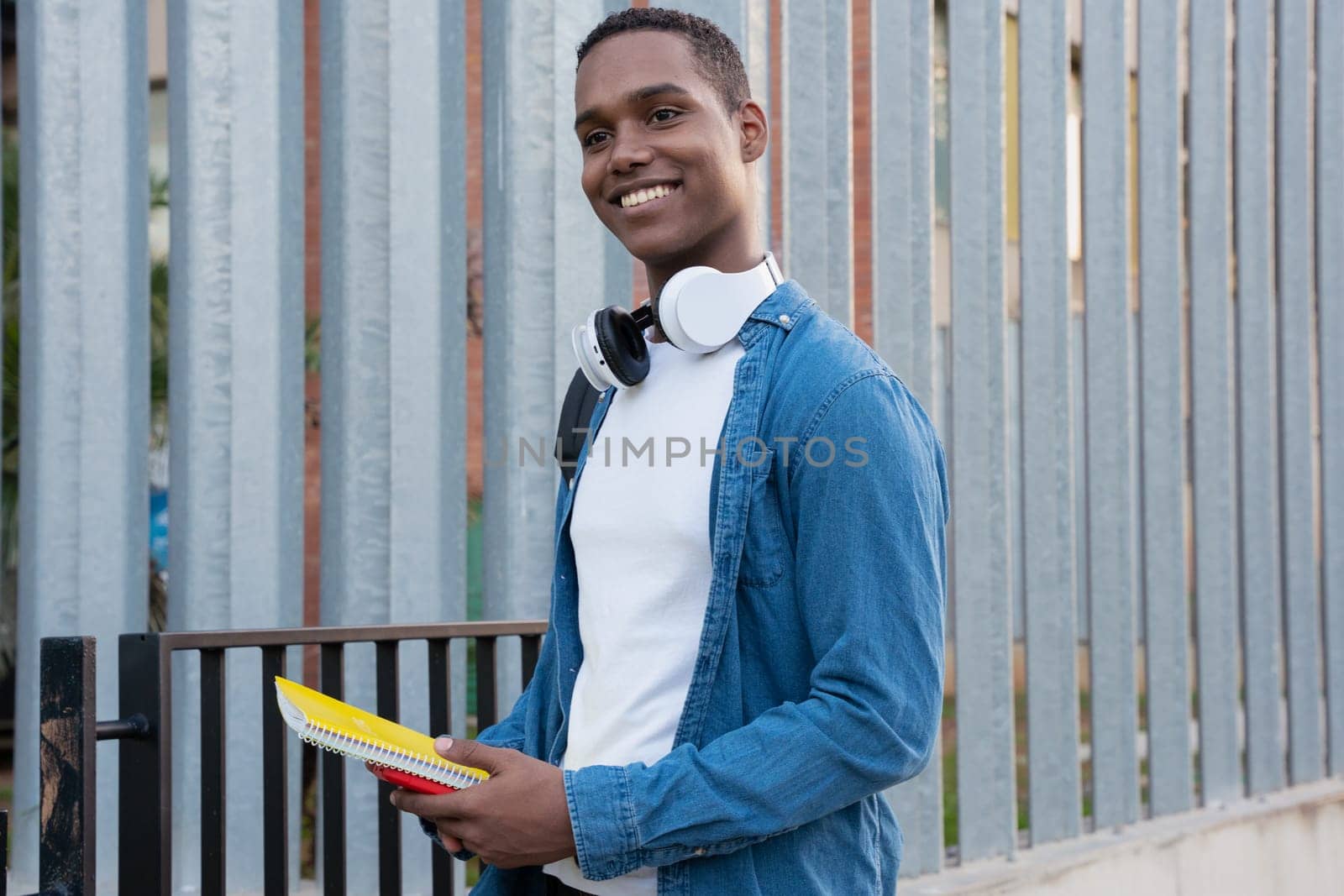 Young black man standing on university campus.College life concept