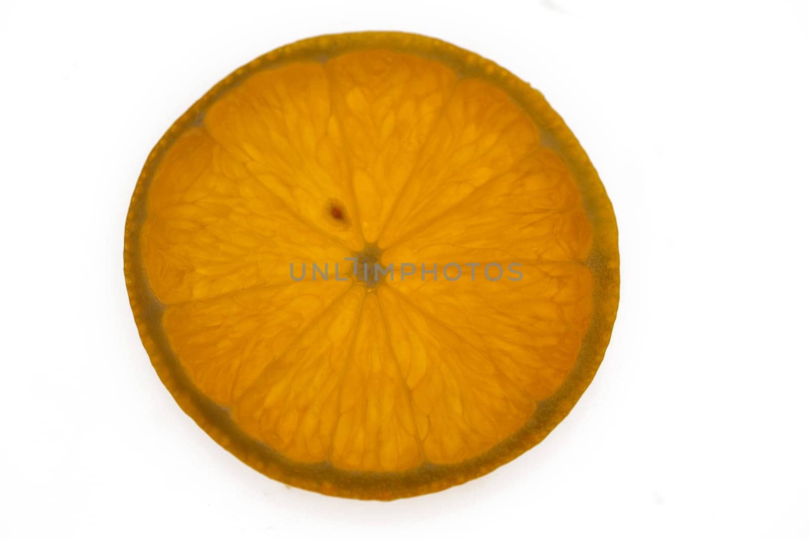 A fresh orange slice showcases its textured flesh and bright color, inviting taste and freshness to the table.
