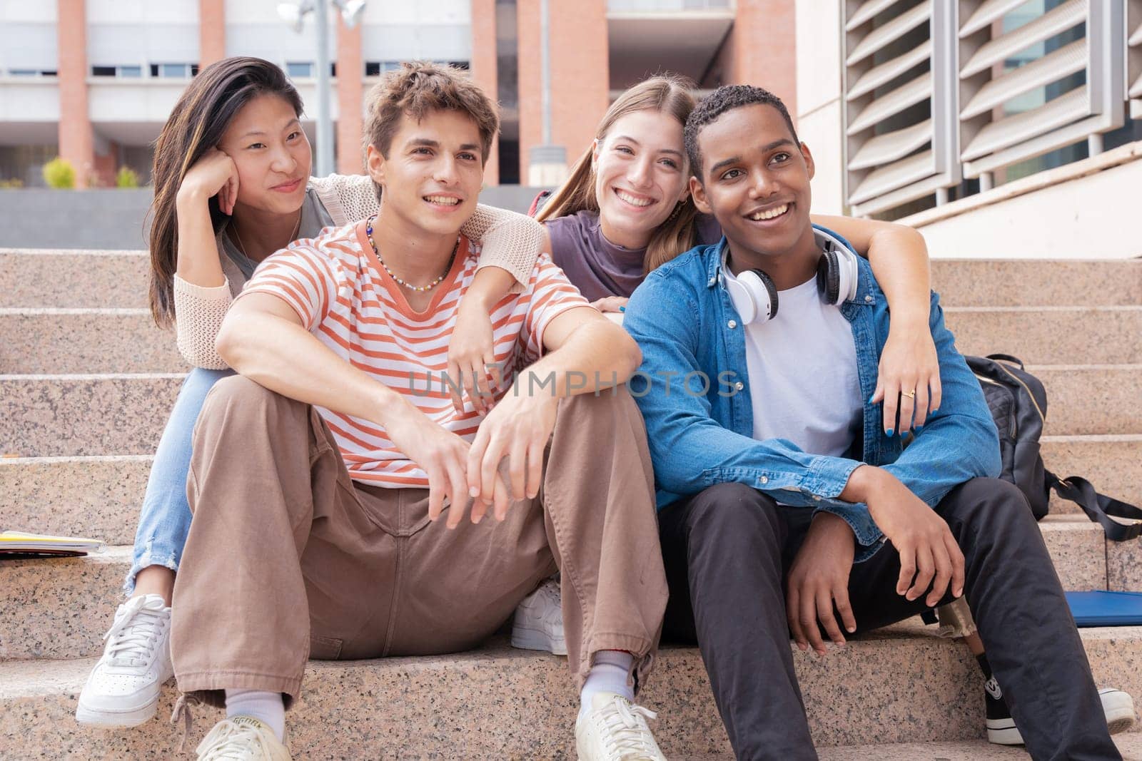 multiracial students gathering on campus. concepts of youth, university life, adolescent and urban life
