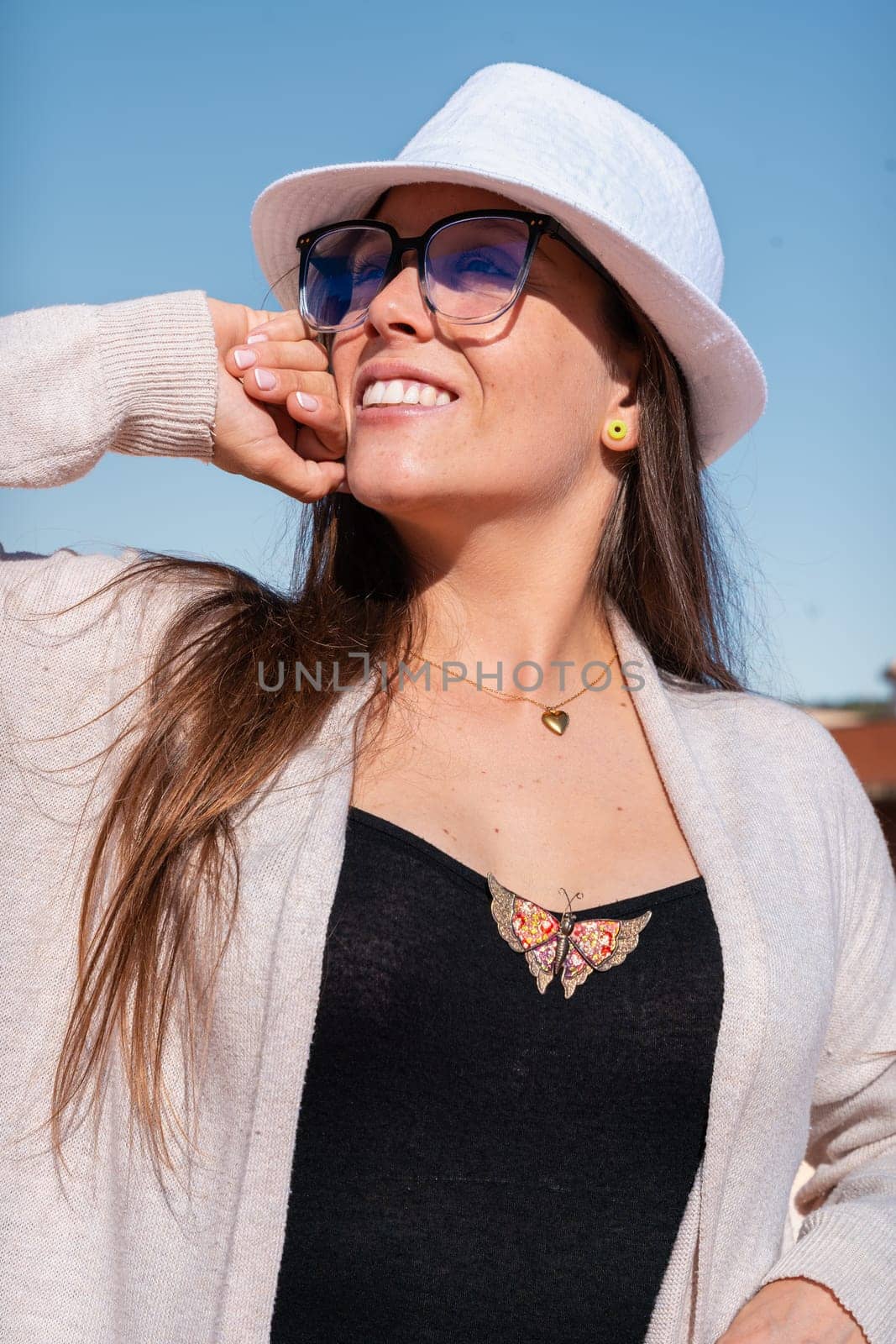 Young caucasian woman smiling at the sky with glasses outdoors. Front view of a young lawyer with positive expression staring