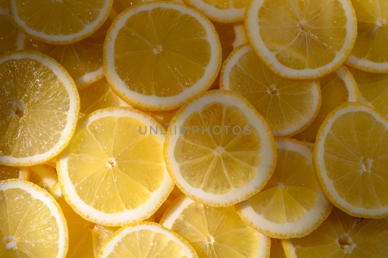 Bright yellow lemon slices lie neatly together, ready to add zest and freshness to dishes or beverages.