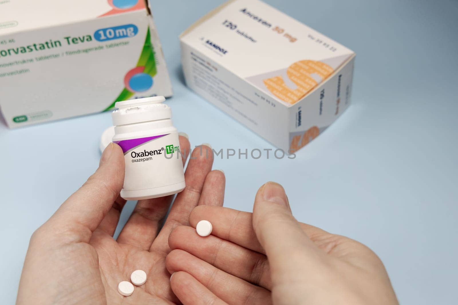 Female hands holding Oxabenz sedative pills. Prescription medication. Copenhagen, Denmark - February 11, 2025