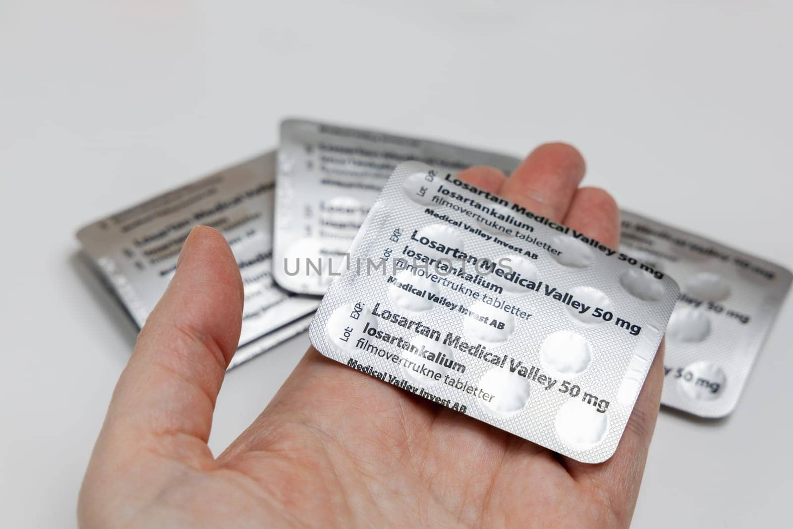 Female hands holding Losartan high blood pressure pills in blister. Prescription medication. Copenhagen, Denmark - February 11, 2025