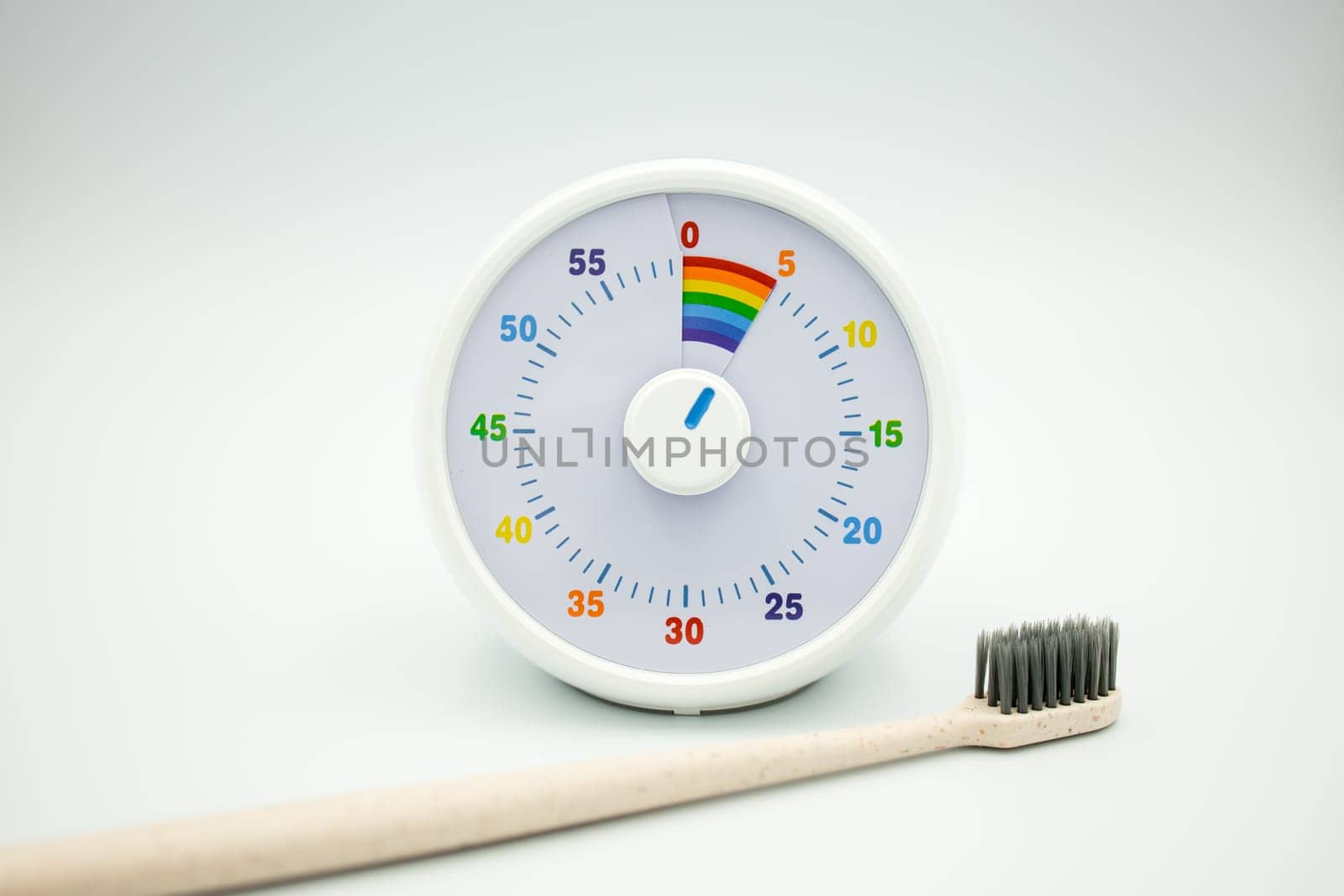 Colorful children timer and toothbrush for effective time management.
