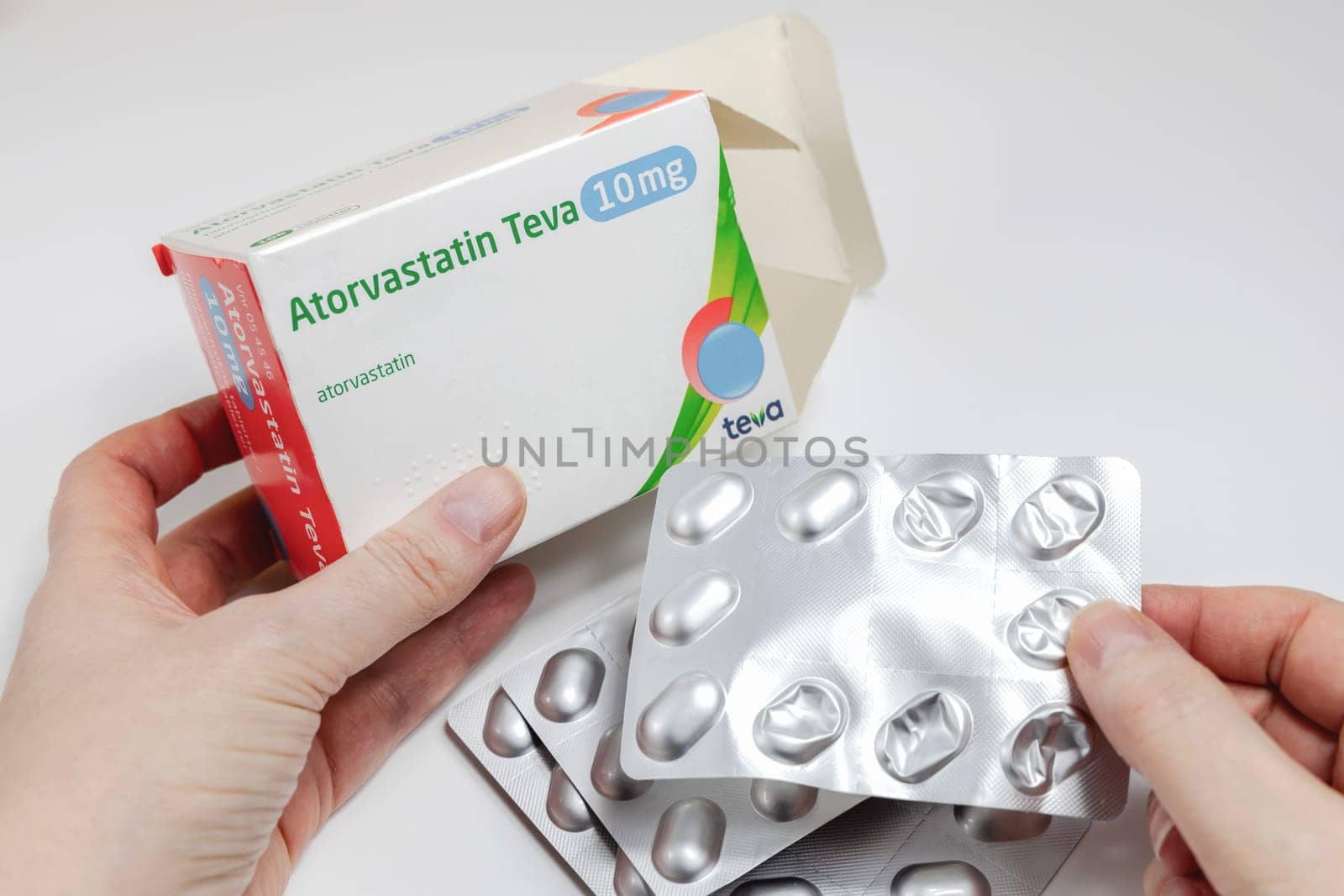 Female hands holding Atorvastatin against high cholesterol in the bkood pills. Copenhagen, Denmark - February 11, 2025